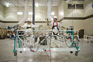 Workers in a basket working on ceiling