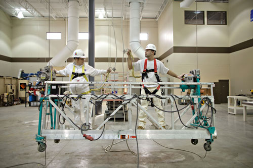 Workers in a basket working on ceiling